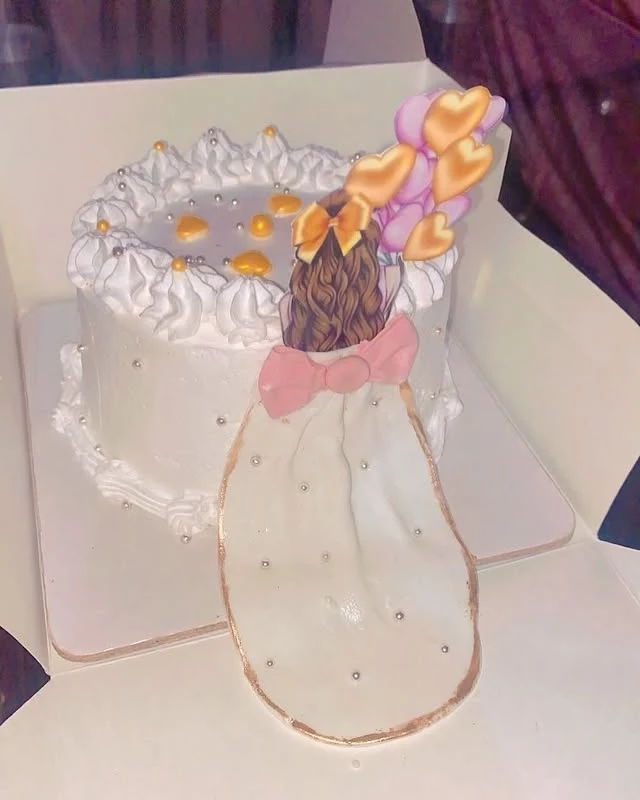 Custom princess theme cake for baby girl with pink bow, gold dots, and orange-pink flowers - Princess Birthday Cakes Karachi By Whisk And Sift
